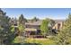 A sunny backyard featuring an elevated deck, covered patio, and lawn at 2317 Wynterbrook Dr, Highlands Ranch, CO 80126