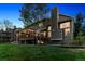 Backyard view with deck, covered patio, and string lights for evening enjoyment at 2317 Wynterbrook Dr, Highlands Ranch, CO 80126