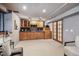 Finished basement with a bar area including wooden cabinets, sink, and counter space, perfect for entertaining at 2317 Wynterbrook Dr, Highlands Ranch, CO 80126