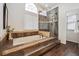 Modern bathroom features a soaking tub, tiled accents, and a glass-enclosed shower at 2317 Wynterbrook Dr, Highlands Ranch, CO 80126