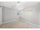 A well-lit, empty bedroom with neutral walls, a carpeted floor, and a bright window at 2317 Wynterbrook Dr, Highlands Ranch, CO 80126