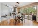 Bright dining area features a modern light fixture, glass table, and access to the wooden deck at 2317 Wynterbrook Dr, Highlands Ranch, CO 80126