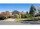 Beautiful home featuring lush greenery, mature trees, and a well-maintained front yard at 2317 Wynterbrook Dr, Highlands Ranch, CO 80126