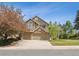 Beautiful two-story home featuring a brick facade and a spacious three-car garage at 2317 Wynterbrook Dr, Highlands Ranch, CO 80126