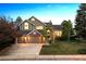 Charming two-story home with a three-car garage and beautifully landscaped front yard at 2317 Wynterbrook Dr, Highlands Ranch, CO 80126