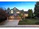 Charming two-story home features a three-car garage and a well-manicured front lawn at 2317 Wynterbrook Dr, Highlands Ranch, CO 80126