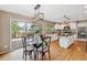 Bright kitchen featuring hardwood floors, an island, and access to outdoor deck at 2317 Wynterbrook Dr, Highlands Ranch, CO 80126
