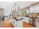 Bright kitchen featuring an island, stainless steel appliances, and hardwood floors at 2317 Wynterbrook Dr, Highlands Ranch, CO 80126