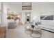 Inviting living room with open layout, modern decor, and seamless flow to kitchen and entry at 2317 Wynterbrook Dr, Highlands Ranch, CO 80126