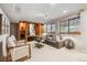 Cozy living room with built-in shelving, comfortable seating, and natural light from the windows at 2317 Wynterbrook Dr, Highlands Ranch, CO 80126
