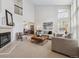 Cozy living room with fireplace, neutral decor, and abundant natural light at 2317 Wynterbrook Dr, Highlands Ranch, CO 80126