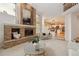 Bright living room features a brick fireplace and views into dining and kitchen areas at 2317 Wynterbrook Dr, Highlands Ranch, CO 80126