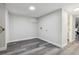 Unfinished basement with wood-look floors and neutral wall paint at 3929 Federal Blvd, Denver, CO 80211
