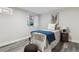This charming bedroom has gray wood floors, white walls, and a delightful elephant print to give the room character at 3929 Federal Blvd, Denver, CO 80211