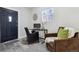 Small office with a black glass desk and a black chair. There is an additional chair for guests at 3929 Federal Blvd, Denver, CO 80211