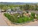 Stunning aerial view of a home with lush lawn, patio, playground, and beautiful landscaping at 895 Nile Ct, Golden, CO 80401