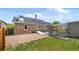 Rear exterior of home featuring stone accents, a gravel yard, and a small patch of grass at 895 Nile Ct, Golden, CO 80401