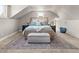 Spacious bedroom with sloped ceilings, neutral tones, and a comfortable seating area at 895 Nile Ct, Golden, CO 80401