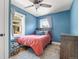 Cozy bedroom with blue walls, a comfortable bed, and natural light from the windows at 895 Nile Ct, Golden, CO 80401