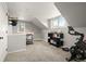 Bright room with sloped ceilings, featuring a home gym and separate living area at 895 Nile Ct, Golden, CO 80401