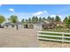 Gravel driveway leading to a home with a detached garage and outdoor seating area at 895 Nile Ct, Golden, CO 80401