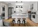 Bright kitchen with white cabinets, stainless steel appliances, kitchen island, and hardwood floors at 895 Nile Ct, Golden, CO 80401