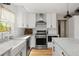 Kitchen with white cabinetry, stainless steel appliances, subway tile backsplash and hardwood floors at 895 Nile Ct, Golden, CO 80401
