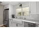 Charming kitchen featuring stainless steel appliances, white cabinetry, farmhouse sink and hardwood floors at 895 Nile Ct, Golden, CO 80401