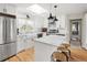 Bright kitchen boasts white cabinetry, stainless steel appliances, marble countertops, and a skylight at 895 Nile Ct, Golden, CO 80401