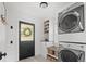 Well-organized laundry room featuring stackable washer and dryer and ample storage at 895 Nile Ct, Golden, CO 80401