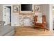 Stylish living room featuring a stone fireplace, hardwood floors, and decorative artwork at 895 Nile Ct, Golden, CO 80401