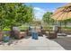 Cozy outdoor patio with wicker seating, accent tables, and pleasant views of the surrounding landscaping at 895 Nile Ct, Golden, CO 80401