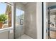Beautiful shower featuring glass doors, gray subway tiles, and white hexagon tiles for a modern aesthetic at 895 Nile Ct, Golden, CO 80401