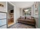 Cozy sun room with a comfortable couch, natural light, and view to the living room at 895 Nile Ct, Golden, CO 80401