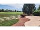 Picturesque backyard view of a golf course, framed by a white fence and lush landscaping at 14232 Piney River Rd, Broomfield, CO 80023