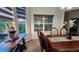 Bright dining room with large windows offering green views, elegant decor, and a formal dining table at 14232 Piney River Rd, Broomfield, CO 80023
