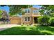 Charming two-story home featuring a stone facade, well-manicured lawn, and an attached two-car garage at 14232 Piney River Rd, Broomfield, CO 80023