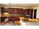 Spacious kitchen with custom cabinetry, granite countertops, an island and stainless steel appliances at 14232 Piney River Rd, Broomfield, CO 80023