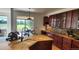 Open kitchen boasts cherry cabinets, granite countertops, an island sink, and stainless steel appliances at 14232 Piney River Rd, Broomfield, CO 80023