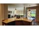 Bright kitchen with bar seating that flows into a living area and features a large island and ample countertops at 14232 Piney River Rd, Broomfield, CO 80023