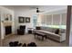 Bright living room features a fireplace, ceiling fan, and large windows offering natural light at 14232 Piney River Rd, Broomfield, CO 80023
