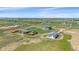 Wide aerial view of the property, showcasing the house, outbuildings, and vast surrounding landscape at 32800 E 137Th Way, Brighton, CO 80603