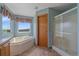 Bathroom with a soaking tub and walk-in shower at 32800 E 137Th Way, Brighton, CO 80603