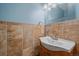 Cozy bathroom featuring a pedestal sink, decorative tile, and a bright, updated vanity mirror at 32800 E 137Th Way, Brighton, CO 80603