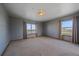 Spacious bedroom with neutral carpeting and large windows with scenic views at 32800 E 137Th Way, Brighton, CO 80603