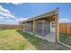 Outdoor kennels for dogs, featuring metal enclosures, concrete flooring, and a shaded roof at 32800 E 137Th Way, Brighton, CO 80603