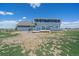 View of the rear exterior featuring a back deck, sliding glass door, and a well-maintained lawn at 32800 E 137Th Way, Brighton, CO 80603