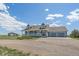 Charming two-story home featuring a welcoming front porch and an attached three-car garage at 32800 E 137Th Way, Brighton, CO 80603