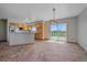 Bright kitchen with modern light fixtures, tile floors, wooden cabinets, and deck access at 32800 E 137Th Way, Brighton, CO 80603