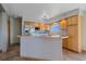 Kitchen island with stainless steel appliances and wooden cabinets at 32800 E 137Th Way, Brighton, CO 80603